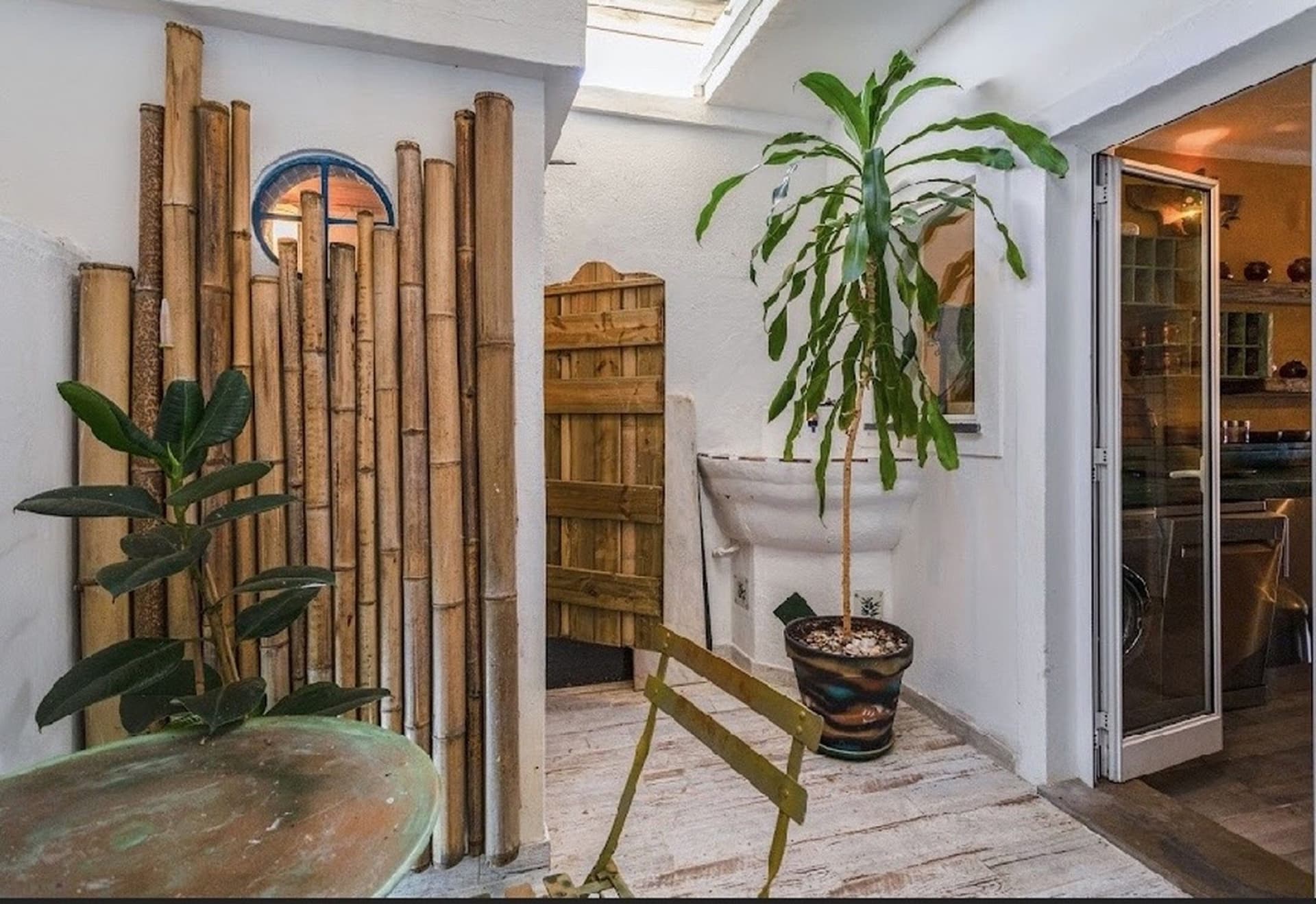 Casa Bispo bamboo patio with tropical plants and skylight