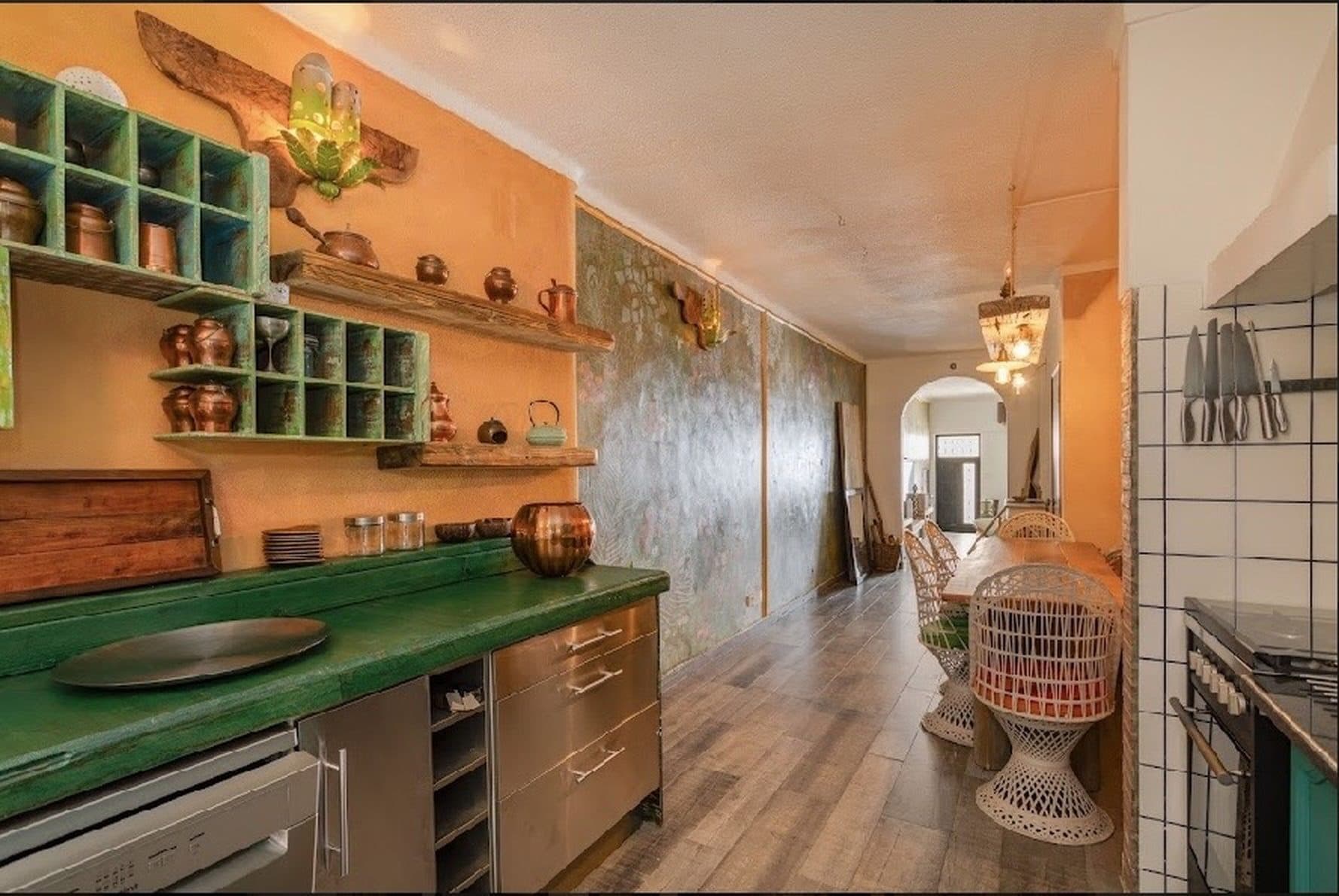 Kitchen with copper cookware and ornate shelving