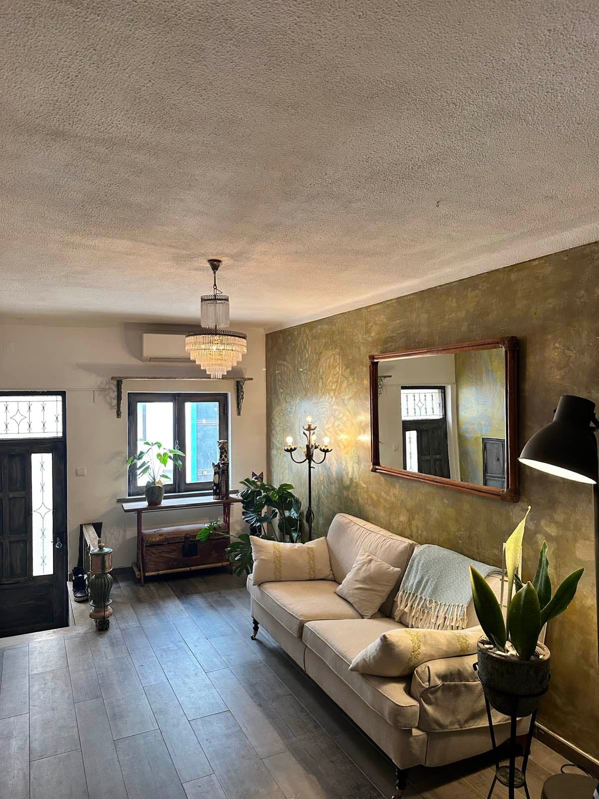 Living room wide view with golden mandala wall and natural light