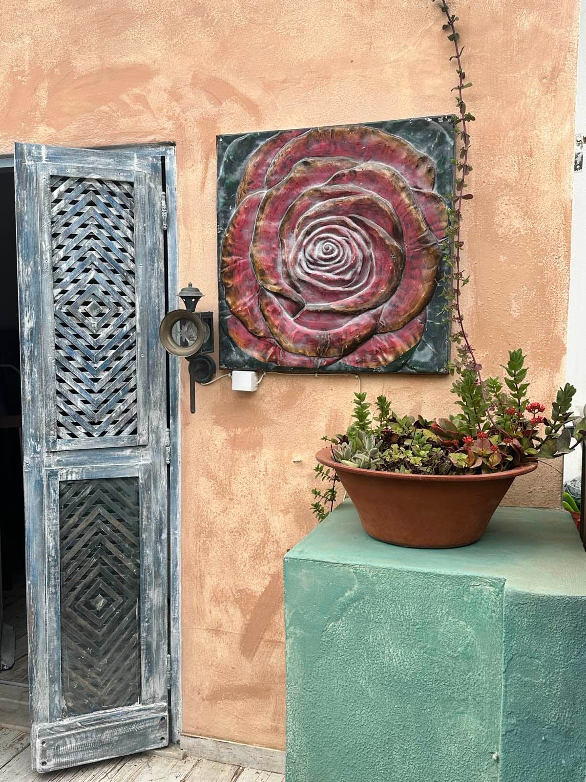 Hand-crafted rose wall art with carved wooden cabinet